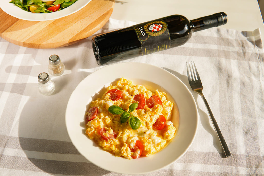 A flavorful Caprese Scramble, cooked to perfection and finished with a drizzle of Croatian olive oil, capturing the essence of a delicious Italian-inspired breakfast.