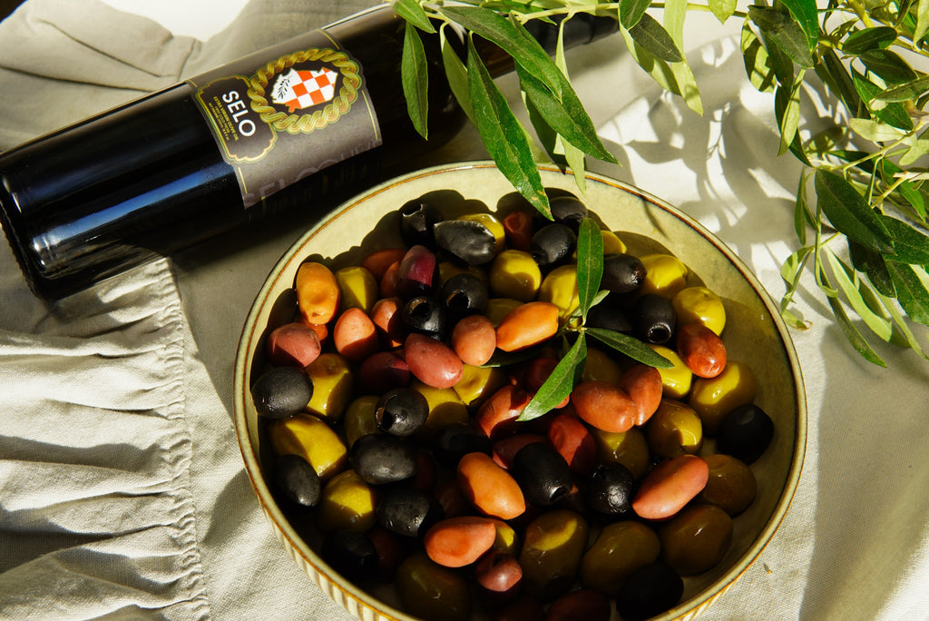 Assortment of olive varieties - a vibrant mix of colors, sizes, and shapes.